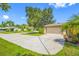 Exterior view of the house showcasing the garage and front yard landscaping at 1461 Cottonwood Ter, Dunedin, FL 34698