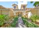 Inviting entrance to a charming two-story building with lush landscaping at 1361 Emerald Dunes, Sun City Center, FL 33573