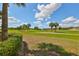 Landscaped area with golf course and lake views at 1361 Emerald Dunes, Sun City Center, FL 33573