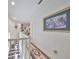 Upper hallway with a view of the staircase and artwork at 1361 Emerald Dunes, Sun City Center, FL 33573