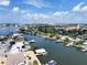 Wide aerial showcasing waterfront homes, canals, and boats on sunny day at 625 80Th Ave, St Pete Beach, FL 33706