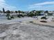 Aerial view of vacant lot, neighboring houses, and palm trees at 625 80Th Ave, St Pete Beach, FL 33706