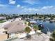 Aerial view of waterfront property with boat slips and neighboring homes at 625 80Th Ave, St Pete Beach, FL 33706