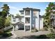 Two story home with gray siding and a charming front porch at 625 80Th Ave, St Pete Beach, FL 33706