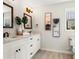 Elegant bathroom featuring a double vanity, white cabinets, and quartz countertops at 2820 N Central Ct, Tampa, FL 33602