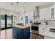 Modern kitchen with white cabinets, blue island, and stainless steel appliances at 2820 N Central Ct, Tampa, FL 33602