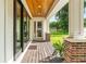Covered patio with wood flooring and brick columns, overlooking the backyard at 2820 N Central Ct, Tampa, FL 33602