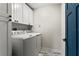 Convenient laundry room with washer, dryer, and white cabinets at 2820 N Central Ct, Tampa, FL 33602