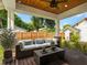 Relaxing covered patio with wooden ceiling and comfortable furniture at 2820 N Central Ct, Tampa, FL 33602