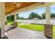 Long covered patio with wood flooring, brick columns, and backyard view at 2820 N Central Ct, Tampa, FL 33602