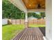Covered back porch with wood deck and ceiling fan overlooks fenced backyard at 2820 N Central Ct, Tampa, FL 33602