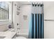 Modern bathroom with white tile, shower, and a small decorative plant at 2820 N Central Ct, Tampa, FL 33602
