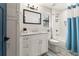 Clean bathroom with a white vanity, shower, and light blue accents at 2820 N Central Ct, Tampa, FL 33602