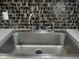 Modern stainless steel kitchen sink with chrome faucet at 3118 Palm Ct, Dunedin, FL 34698