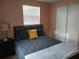 Cozy bedroom with a queen-size bed and ample closet space at 3118 Palm Ct, Dunedin, FL 34698