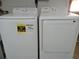Laundry room with side-by-side Samsung washer and dryer at 3118 Palm Ct, Dunedin, FL 34698
