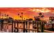 Stunning sunset over a marina with boats and docks at 3118 Palm Ct, Dunedin, FL 34698