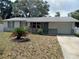 Single-story home with attached garage and landscaping at 3118 Palm Ct, Dunedin, FL 34698