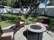 Relaxing backyard with fire pit, seating area, and hammock at 3118 Palm Ct, Dunedin, FL 34698
