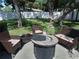 Relaxing backyard with fire pit and patio furniture at 3118 Palm Ct, Dunedin, FL 34698