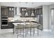 Modern kitchen with gray cabinetry, stainless steel appliances, an island with seating, and pendant lighting at 13714 Heartwood Way, Parrish, FL 34219