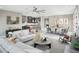 Open-concept living room with a dining area and kitchen view, showcasing modern furnishings and decor at 13714 Heartwood Way, Parrish, FL 34219