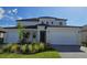 Two-story house with a three-car garage at 7045 E 113Th Ct, Palmetto, FL 34221