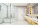 Modern bathroom with a soaking tub, double vanity, and a glass-enclosed shower at 8936 Williams Rd, Seffner, FL 33584