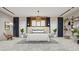 Modern bedroom with large bed, herringbone floors and stylish decor at 8936 Williams Rd, Seffner, FL 33584