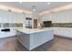 Modern kitchen with large island, white cabinetry, and green tile backsplash at 2509 N Dundee St, Tampa, FL 33629