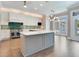 Bright kitchen features a large island, stainless steel appliances, and access to backyard at 2509 N Dundee St, Tampa, FL 33629