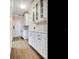 White pantry with glass-front cabinets and ample storage space at 2509 N Dundee St, Tampa, FL 33629
