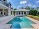 Refreshing blue pool, spacious patio, and a view of the home at 2509 N Dundee St, Tampa, FL 33629