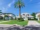 Two-story house with gray metal roof, landscaping, and paved driveway at 2509 N Dundee St, Tampa, FL 33629
