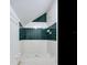 Small bathroom with a green and white tile shower at 2509 N Dundee St, Tampa, FL 33629