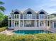 Two-story house with pool, lush landscaping, and waterfront view at 2509 N Dundee St, Tampa, FL 33629