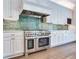 High-end stainless steel range and range hood in a white kitchen at 2509 N Dundee St, Tampa, FL 33629