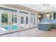 Kitchen with pool view, green cabinets and island, and white french doors at 2509 N Dundee St, Tampa, FL 33629