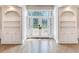Bright entryway with hardwood floors, built-in shelves, and elegant doors at 2509 N Dundee St, Tampa, FL 33629