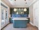 Modern kitchen with green cabinets, quartz island, and blue tile backsplash at 2509 N Dundee St, Tampa, FL 33629