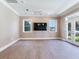 Living room with hardwood floors, ceiling fan and french doors at 2509 N Dundee St, Tampa, FL 33629