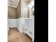 Powder room with white vanity and wood-look flooring at 2509 N Dundee St, Tampa, FL 33629