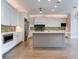 Gourmet kitchen with island, stainless steel appliances, and green tile backsplash at 2509 N Dundee St, Tampa, FL 33629