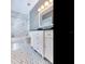 Elegant bathroom with marble tile, white vanity, and mosaic floor at 2509 N Dundee St, Tampa, FL 33629