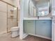 Modern bathroom with a walk-in shower, floating vanity, and elegant mirror at 2509 N Dundee St, Tampa, FL 33629