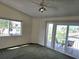 Bright bedroom with carpet, ceiling fan, and access to balcony at 346 Madeira Cir, St Petersburg, FL 33715