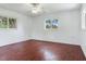 Spacious bedroom with hardwood floors and ceiling fan at 7301 Pierce Harwell Rd, Plant City, FL 33565