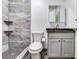 Bathroom features gray marble-look tile shower, gray vanity, granite countertop at 7301 Pierce Harwell Rd, Plant City, FL 33565