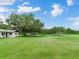 Spacious lot with a home, lush green grass, and mature trees at 7301 Pierce Harwell Rd, Plant City, FL 33565