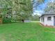 Landscaped backyard with shed and mature trees at 7301 Pierce Harwell Rd, Plant City, FL 33565